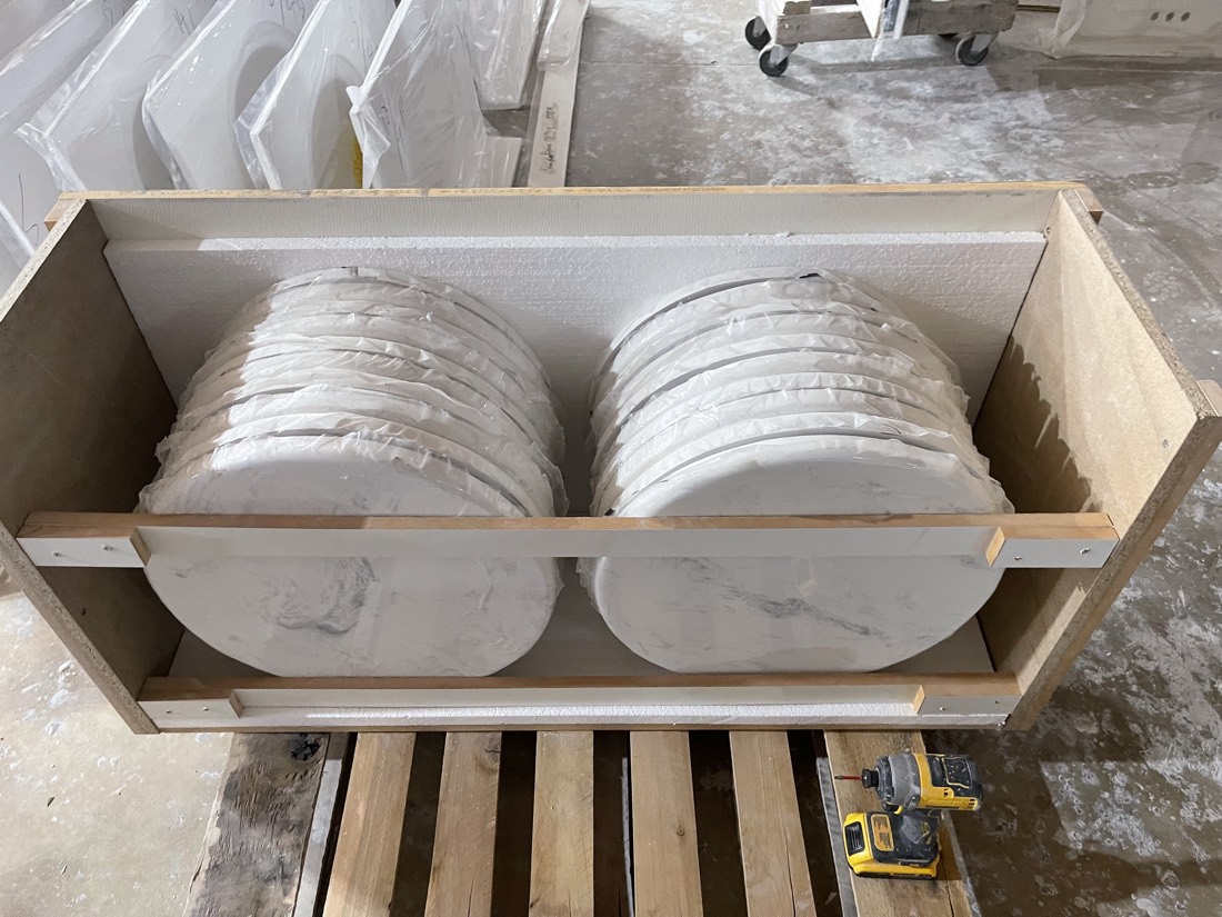 Marble-Lite table tops crated on the factory floor in Miami