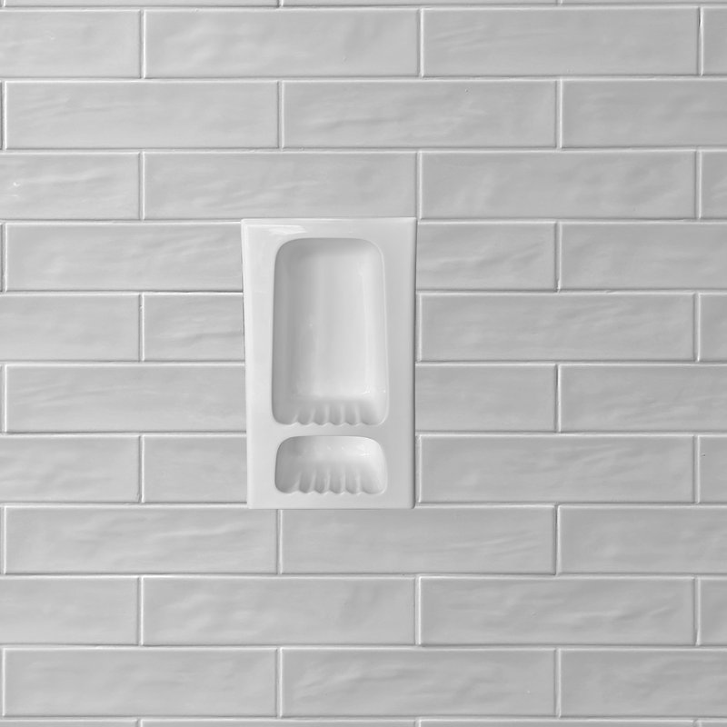 Tall shampoo niche set into a subway wall panel