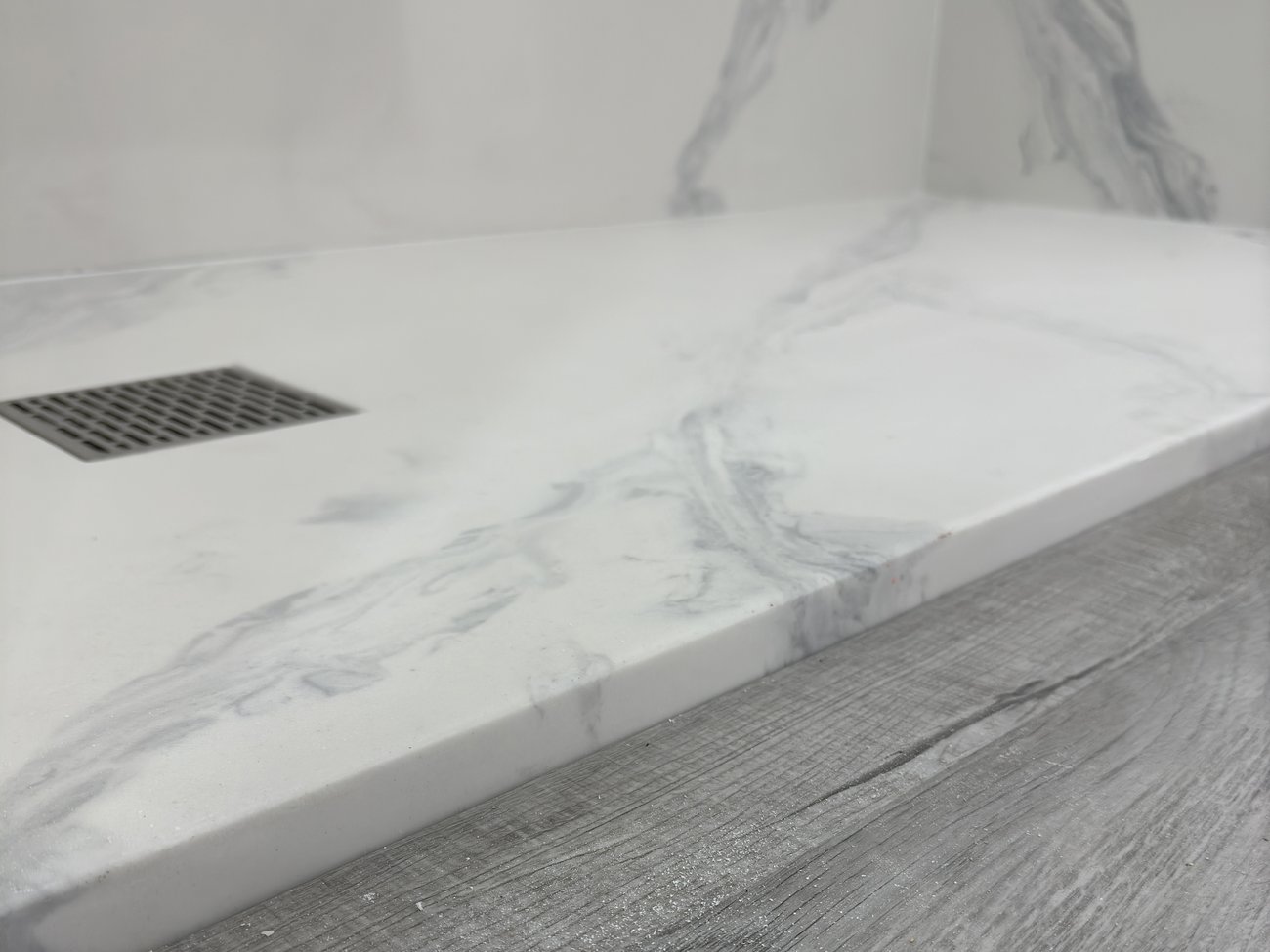 One-piece cultured marble shower pan